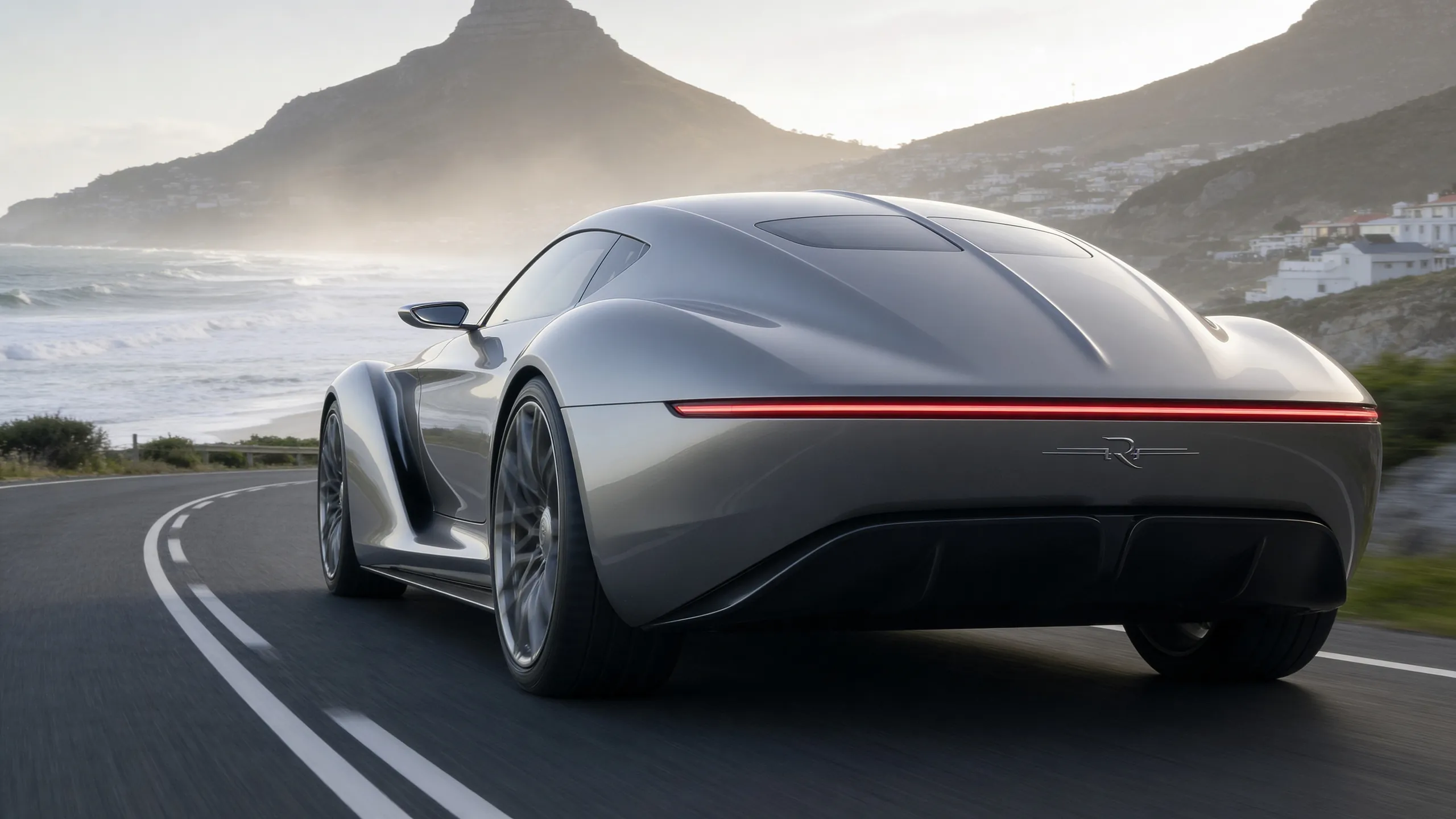 Rear of the Mirage concept car on a coastal road with surf and mountains